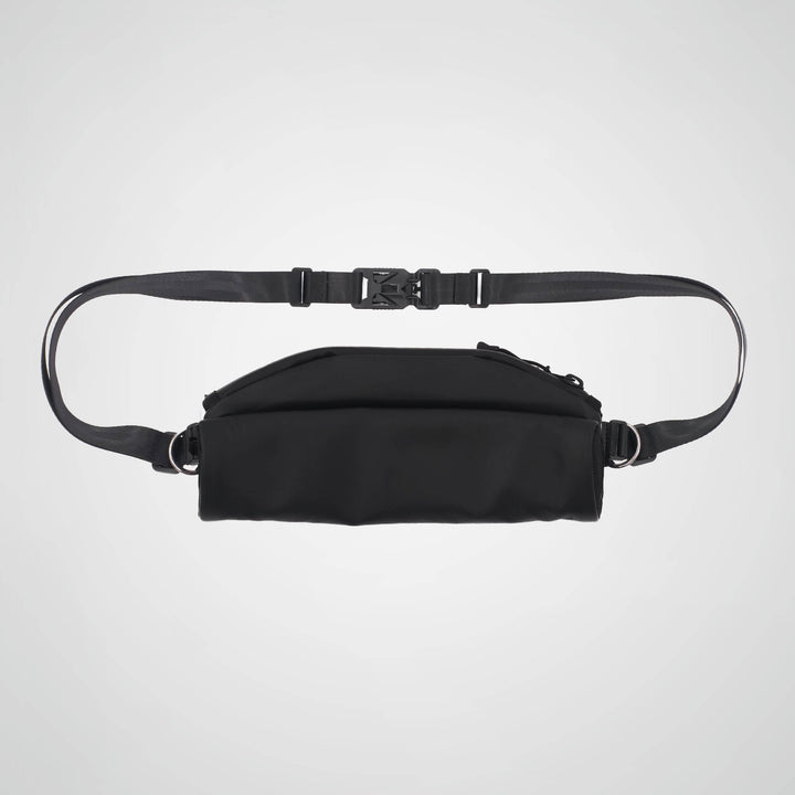 Black waist bag with a strap on a light gray background