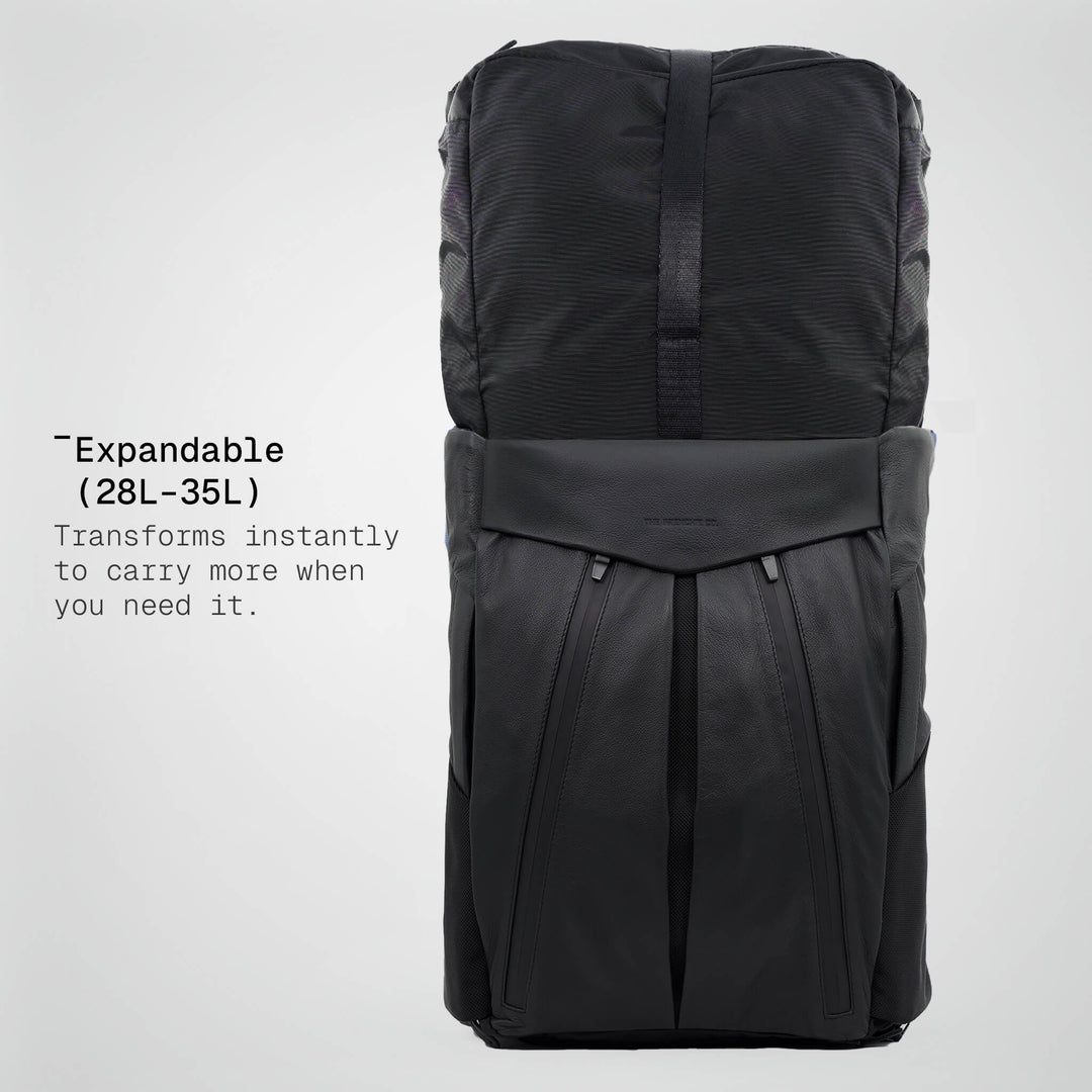 Black expandable backpack on a light gray background
