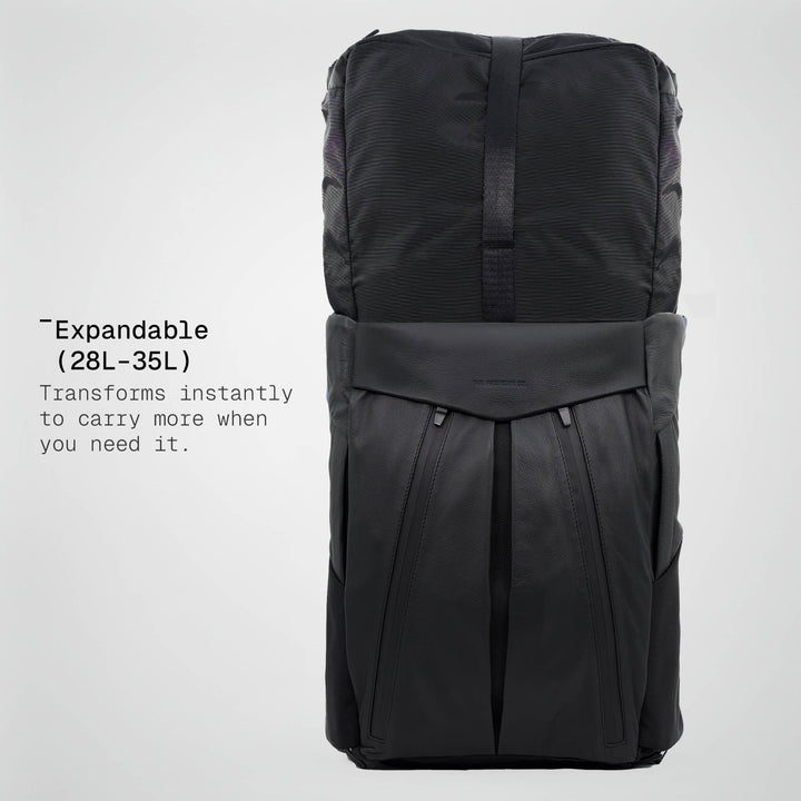 Black expandable backpack on a light gray background