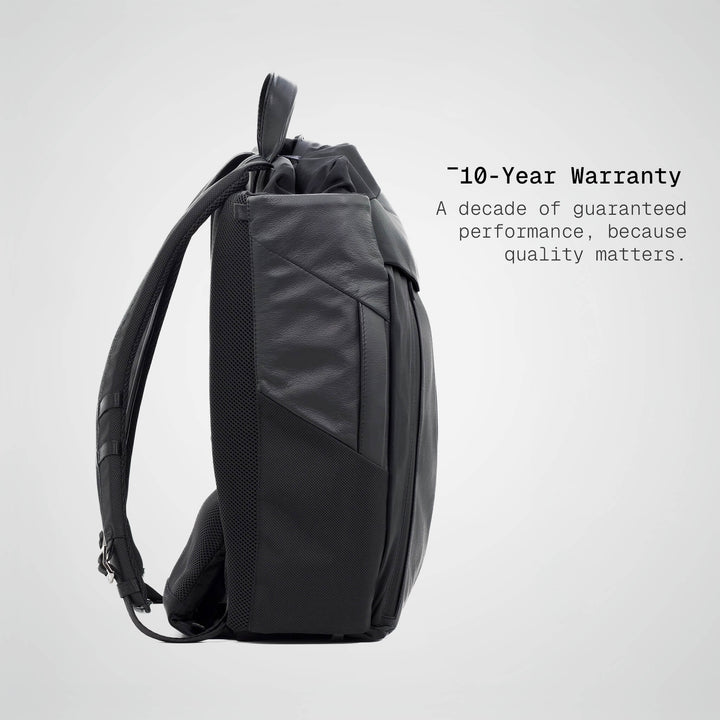 Black backpack on a light gray background with text about a 10-year warranty.