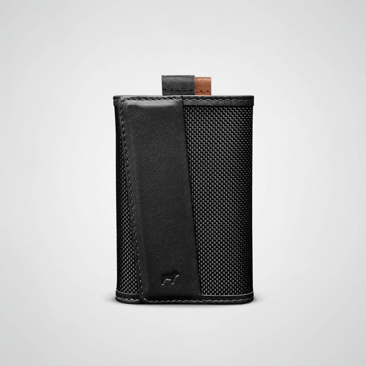 Black leather wallet with textured pattern on a light gray background