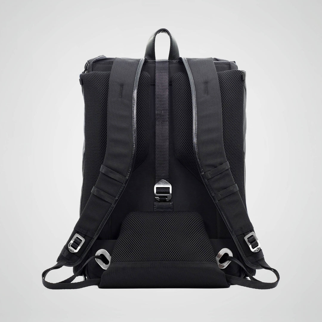 Black backpack with straps on a light gray background