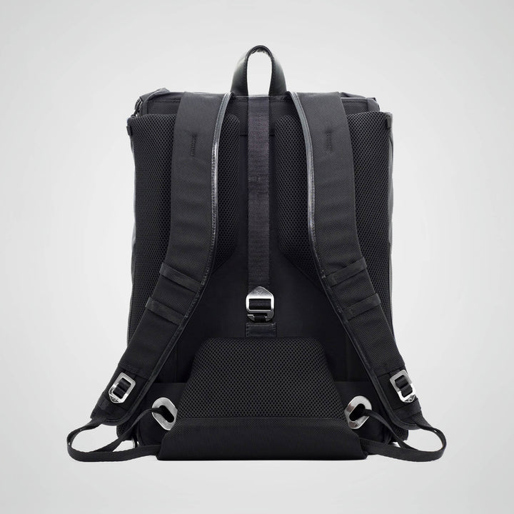 Black backpack with straps on a light gray background
