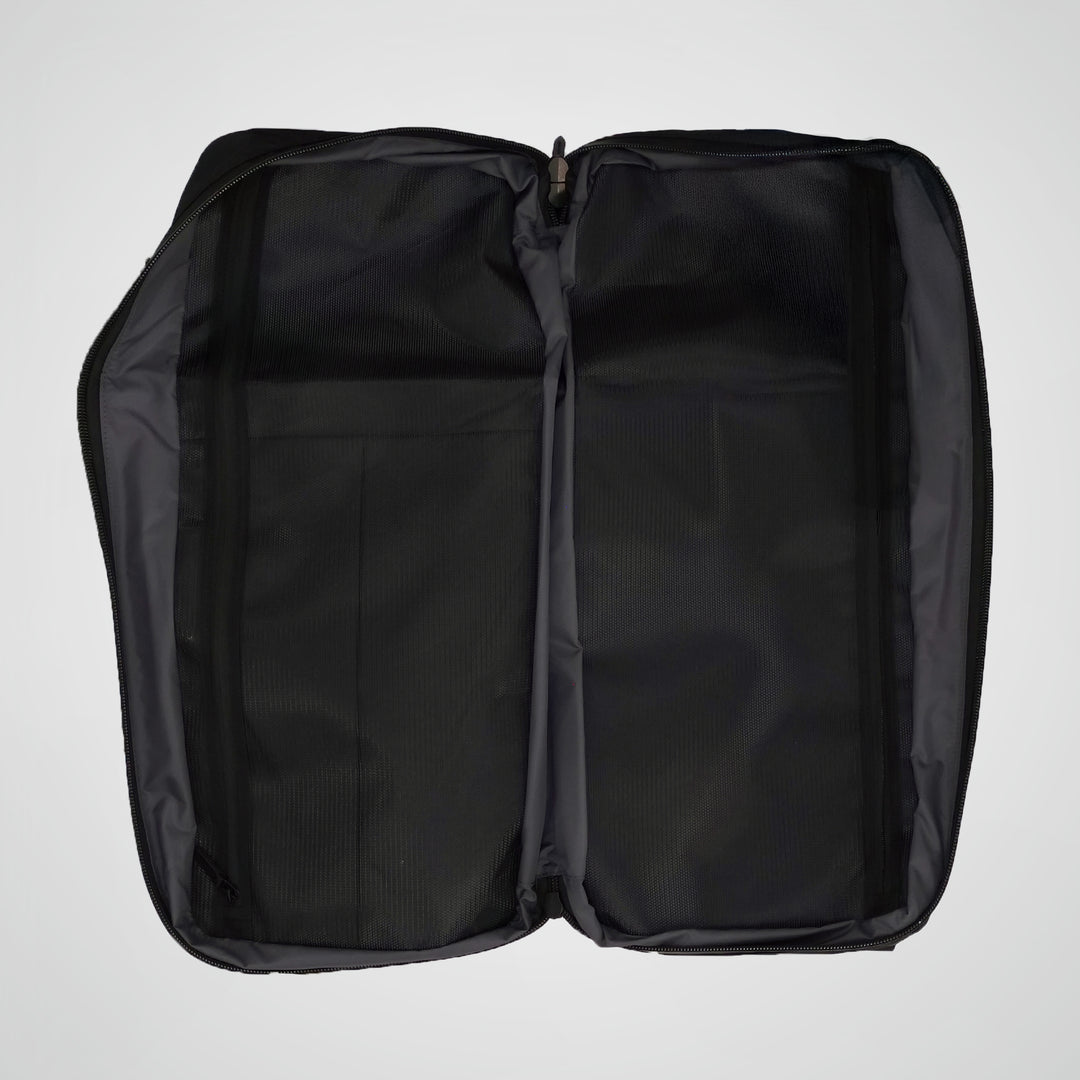 Black backpack with open compartments on a light gray background