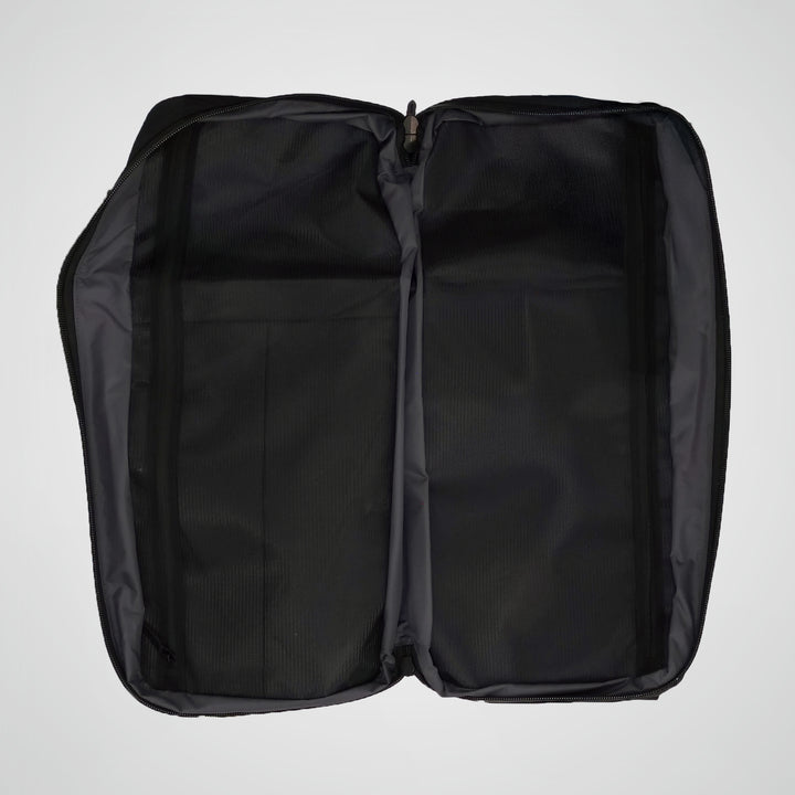 Black backpack with open compartments on a light gray background